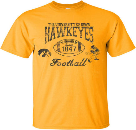 This old school Iowa football design has The University of Iowa Hawkeyes above a football. Inside the football has Since 1847. This design also has the Tigerhawk and the Old School Football Herky. Printed on a gold t-shirt with black ink.