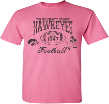 This old school Iowa football design has The University of Iowa Hawkeyes above a football. Inside the football has Since 1847. This design also has the Tigerhawk and the Old School Football Herky.  Printed on a pink t-shirt with black ink. 