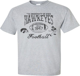 This old school Iowa football design has The University of Iowa Hawkeyes above a football. Inside the football has Since 1847, the year the University of Iowa was founded. This design also has the Tigerhawk and the Old School Football Herky.  Printed on pre-shrunk, 90/10 poly/cotton light gray t-shirt with black ink. All of our Iowa Hawkeye designs are Officially Licensed and approved by the University of Iowa.