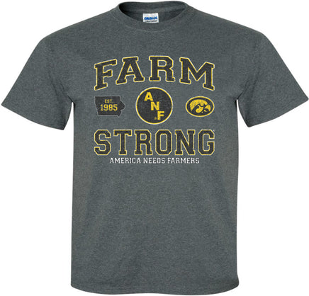A dark gray short-sleeve t-shirt with a distressed black, white and gold design on the front that reads 'FARM STRONG' with 'AMERICA NEEDS FARMERS' underneath, alongside the ANF logo and the Iowa Hawkeyes Tigerhawk logo.