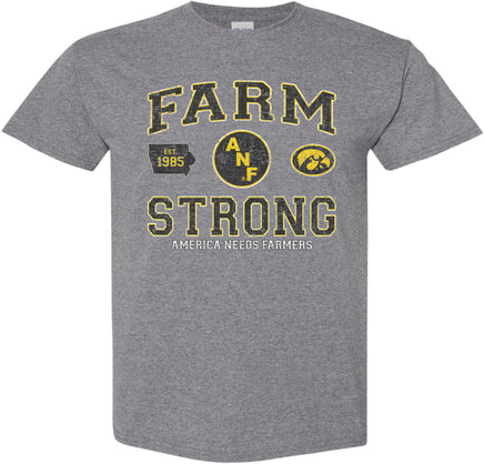 A medium gray short-sleeve t-shirt with a distressed black, white and gold design on the front that reads 'FARM STRONG' with 'AMERICA NEEDS FARMERS' underneath, alongside the ANF logo and the Iowa Hawkeyes Tigerhawk logo.