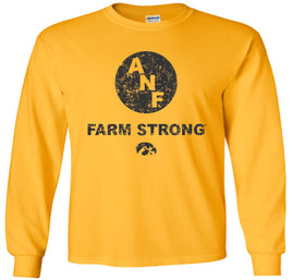 A gold long-sleeve t-shirt with a distressed black design on the front featuring the letters 'ANF' inside a circle, the text 'FARM STRONG', and the Iowa Hawkeyes Tigerhawk logo below.
