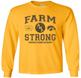 A gold long-sleeve t-shirt with a distressed black design on the front that reads 'FARM STRONG' with 'AMERICA NEEDS FARMERS' underneath, alongside the ANF logo and the Iowa Hawkeyes Tigerhawk logo.
