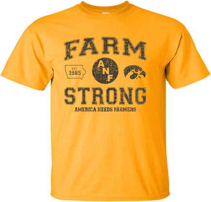 A gold short-sleeve t-shirt with a distressed black design on the front that reads 'FARM STRONG' with 'AMERICA NEEDS FARMERS' underneath, alongside the ANF logo and the Iowa Hawkeyes Tigerhawk logo.