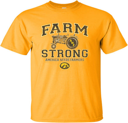A gold short-sleeve t-shirt with a distressed black, white and gold design on the front that reads 'FARM STRONG' and 'AMERICA NEEDS FARMERS' with an old tractor and the Iowa Hawkeyes Tigerhawk logo.